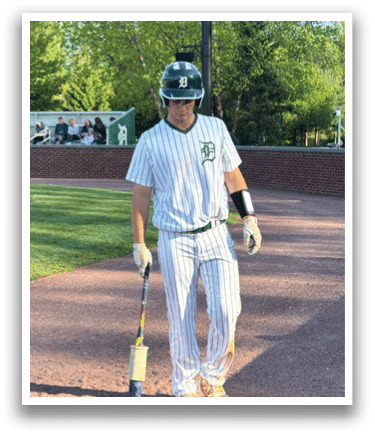 A baseball player is standing on a baseball field holding a bat. Description generated by AI