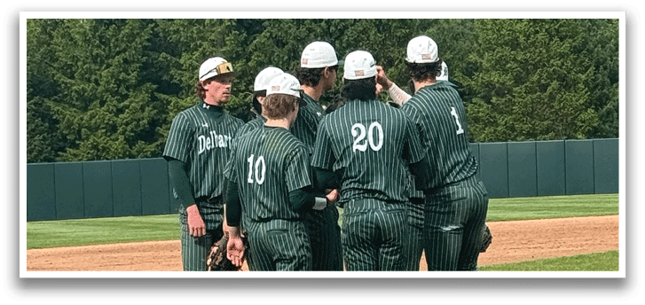 A group of baseball players wearing green and white uniforms standing on a baseball field. Description generated by AI