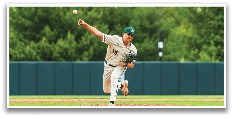 A baseball player in a white uniform is pitching a ball. Description generated by AI