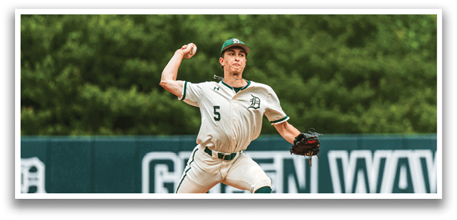 A baseball player in a white uniform is pitching a ball. Description generated by AI