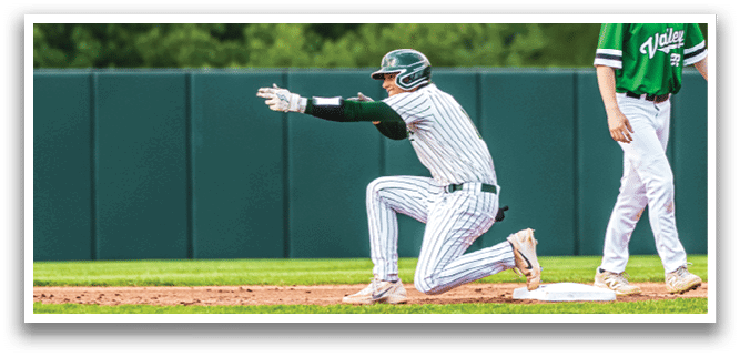 A baseball player is kneeling on the ground. Description generated by AI