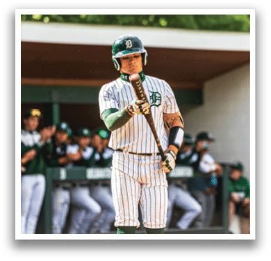 A baseball player holding a bat. Description generated by AI