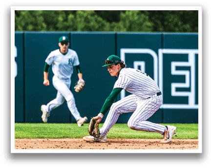 A baseball player in a green and white uniform is sliding into a base. Description generated by AI