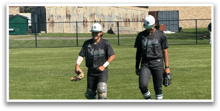 Two baseball players walking on a field. Description generated by AI