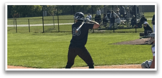 A baseball player is swinging a bat at a ball. Description generated by AI