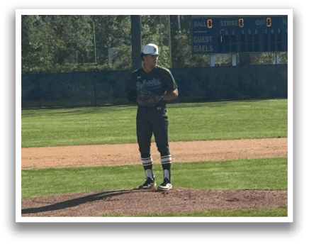 A baseball player standing on the pitcher's mound. Description generated by AI