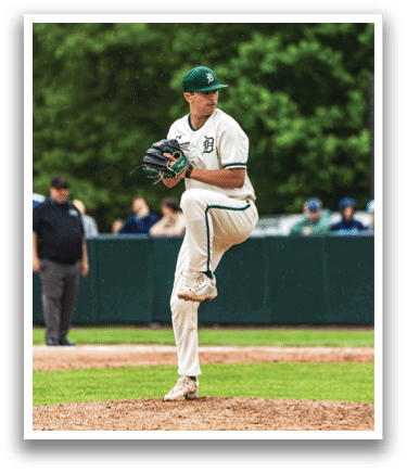 A baseball player in a white uniform is on the mound. Description generated by AI