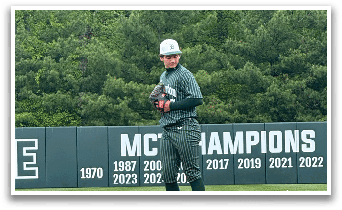 A baseball player standing on a pitcher's mound. Description generated by AI