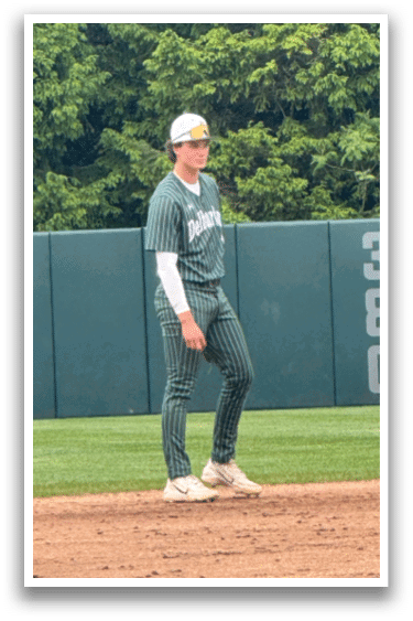 A baseball player standing on the field. Description generated by AI