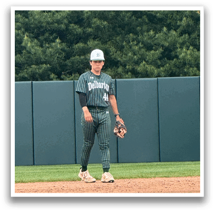 A baseball player is standing on the field. Description generated by AI