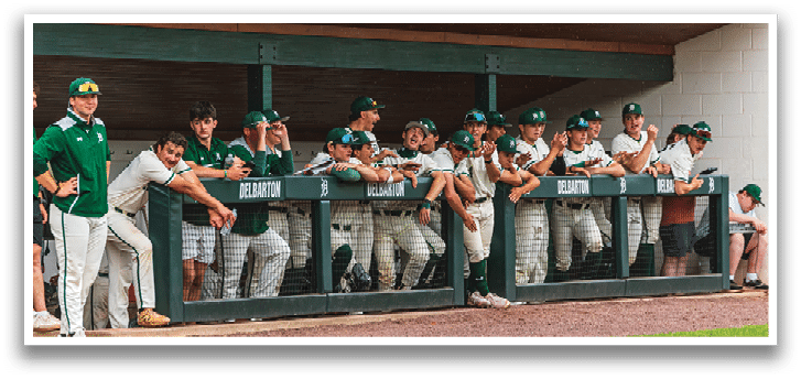 A group of baseball players sitting on a bench. Description generated by AI