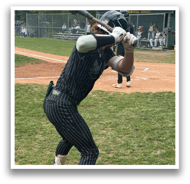 A baseball player in a striped uniform is swinging a bat. Description generated by AI