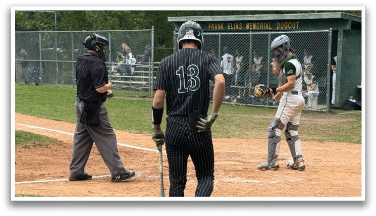 A baseball player with the number 13 on his jersey walks away from home plate. Description generated by AI