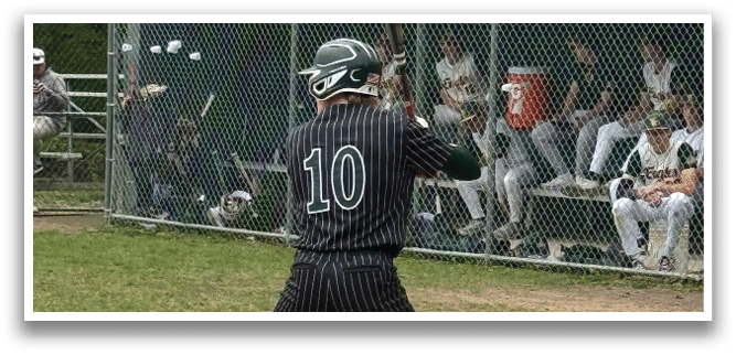 A baseball player is at bat, holding a bat and wearing a black and white uniform. Description generated by AI