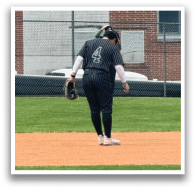 A baseball player is standing on the field. Description generated by AI