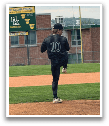 A baseball player is standing on the pitcher's mound. Description generated by AI