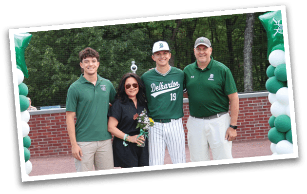 A group of people standing in front of a green and white banner. Description generated by AI