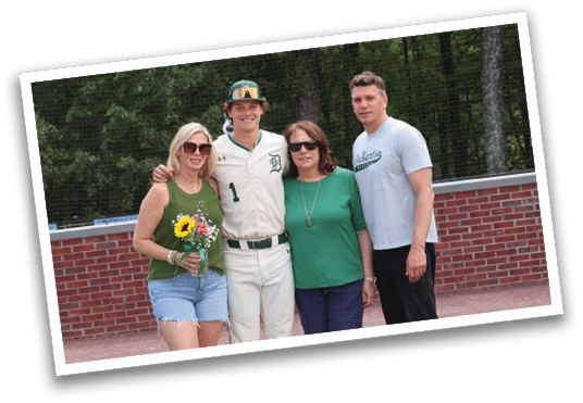 A group of people standing in front of a brick wall. Description generated by AI