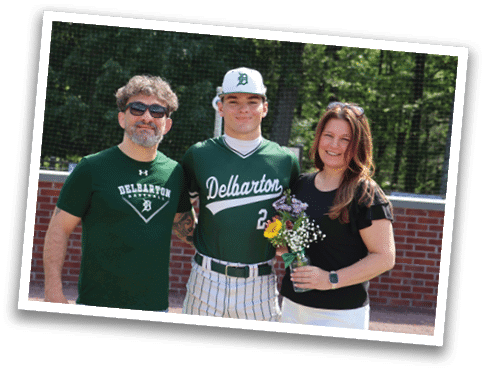 A man and woman are standing next to a baseball player. Description generated by AI