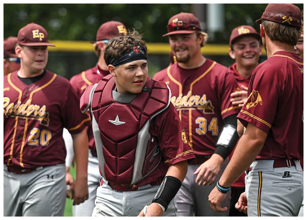 A group of football players on a field, one of them holding a football. AI generated content