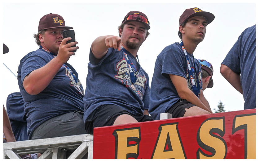 A group of football players on a field, one of them holding a football. AI generated content