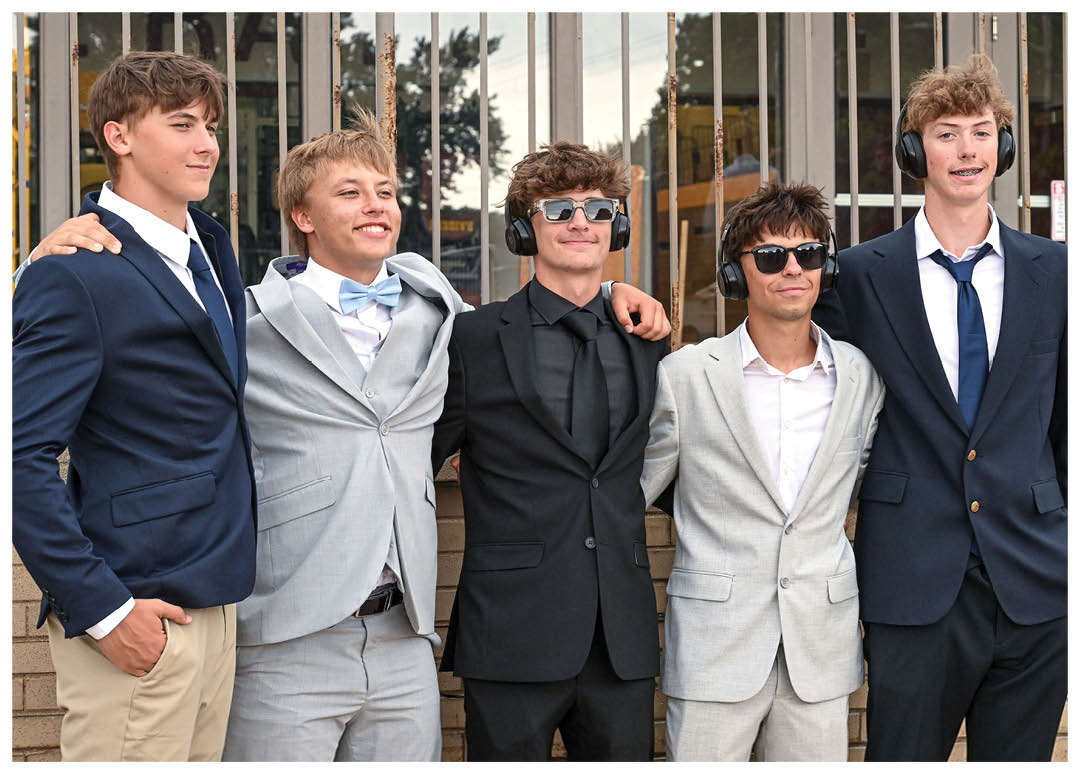 A group of football players on a field, one of them holding a football. AI generated content