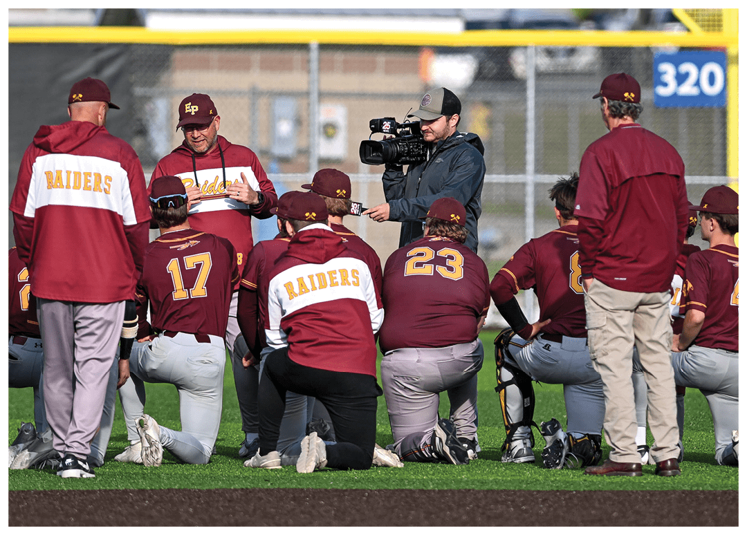 A group of football players on a field, one of them holding a football. AI generated content