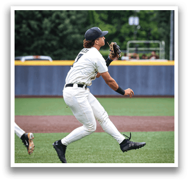 A baseball player in a white uniform is leaping in the air to catch a ball. AI generated content