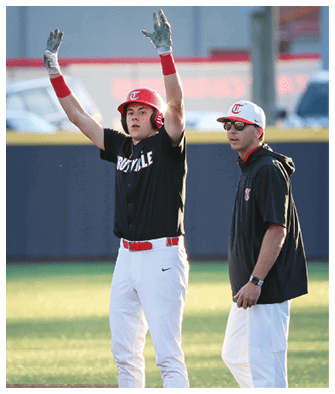 A baseball player celebrates with a high five while a coach watches. AI generated content