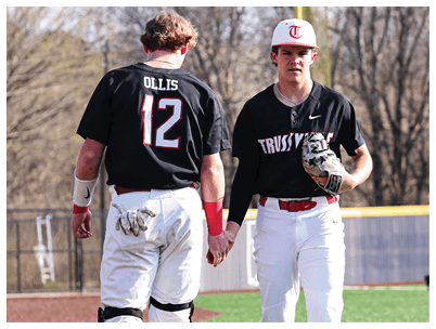 Two baseball players wearing black shirts and white pants are walking on the field. AI generated content