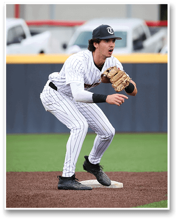 A baseball player in a white and black uniform is crouching on the field, holding a baseball glove. AI generated content