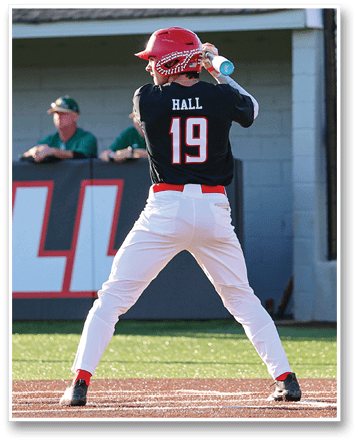 A baseball player in a black and red uniform is swinging a bat at a ball. AI generated content