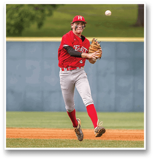 A baseball player in a red and white uniform is about to catch a ball. AI generated content