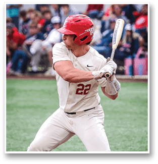 A baseball player in a white uniform is swinging a bat on a field. AI generated content