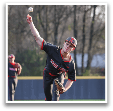 A baseball player in a black shirt and hat is pitching a ball. AI generated content