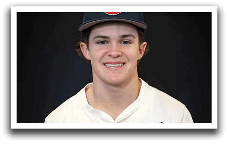 A young man wearing a baseball uniform and a T hat is smiling for the camera. AI generated content