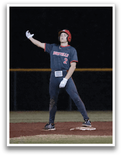 A baseball player is standing on the field, wearing a helmet and pointing his finger upwards. AI generated content