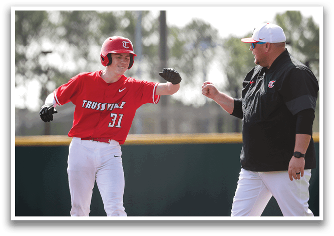 A baseball player wearing a red shirt and white pants is walking off the field. A coach is walking towards him, shaking his hand. AI generated content