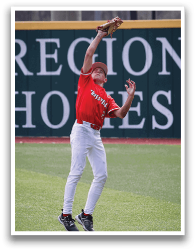 A baseball player in a red shirt and white pants leaps to catch a ball. AI generated content