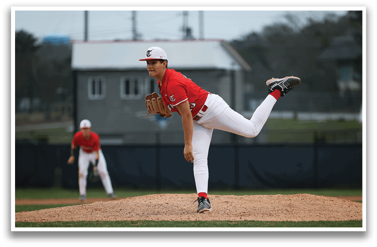 A baseball player in a red shirt and white pants is pitching a ball on a field. AI generated content