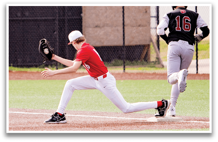 A baseball player in a red shirt is sliding into a base while another player in a black shirt and white pants watches. AI generated content