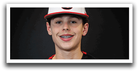 A young man wearing a black and red baseball jersey with the word “Huskies" on the front. AI generated content