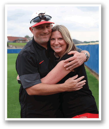 A man and woman are hugging on a baseball field. AI generated content