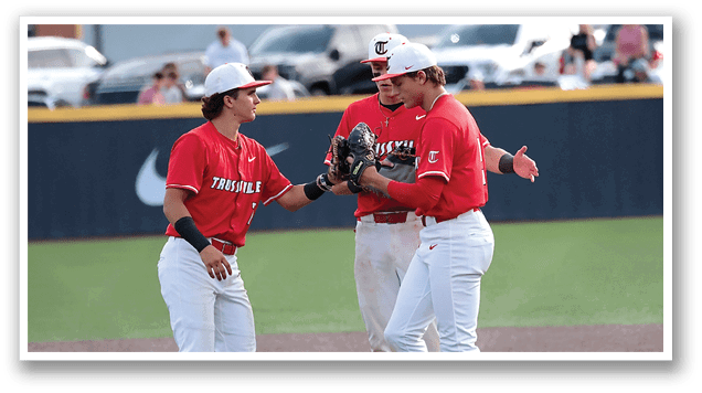 Three baseball players wearing red shirts and white pants are standing on a field. AI generated content