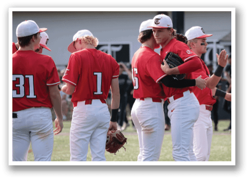 A group of baseball players wearing red jerseys and white pants are standing on a field. They are talking to each other and shaking hands. AI generated content