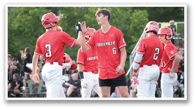 A group of baseball players wearing red jerseys are standing on a field. One player is holding up his hand while another player is waving. AI generated content