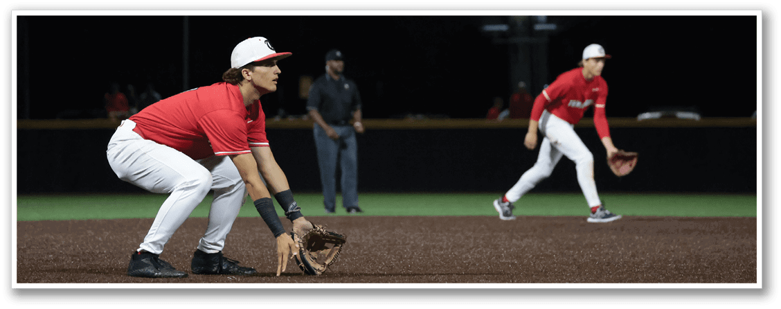 Two baseball players are on the field, one is in the process of catching a ball while the other is running. AI generated content