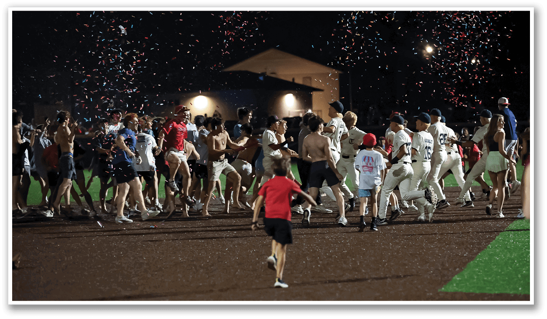 A group of people are celebrating on a field, with some of them wearing red shirts. A young boy is among them, and a dog is also present in the scene. AI generated content