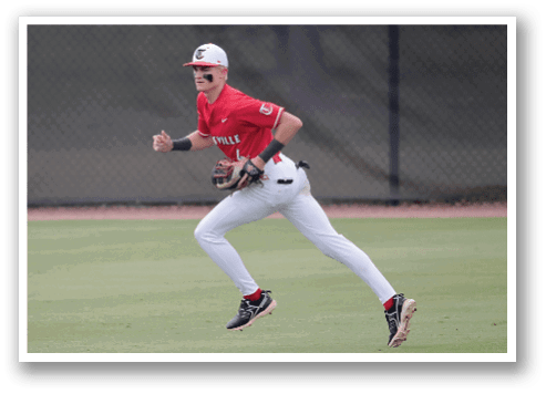 A baseball player wearing a red shirt and white pants is running on the field. AI generated content