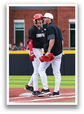 Three baseball players are on the field, talking to an umpire. One player is wearing a red helmet. AI generated content